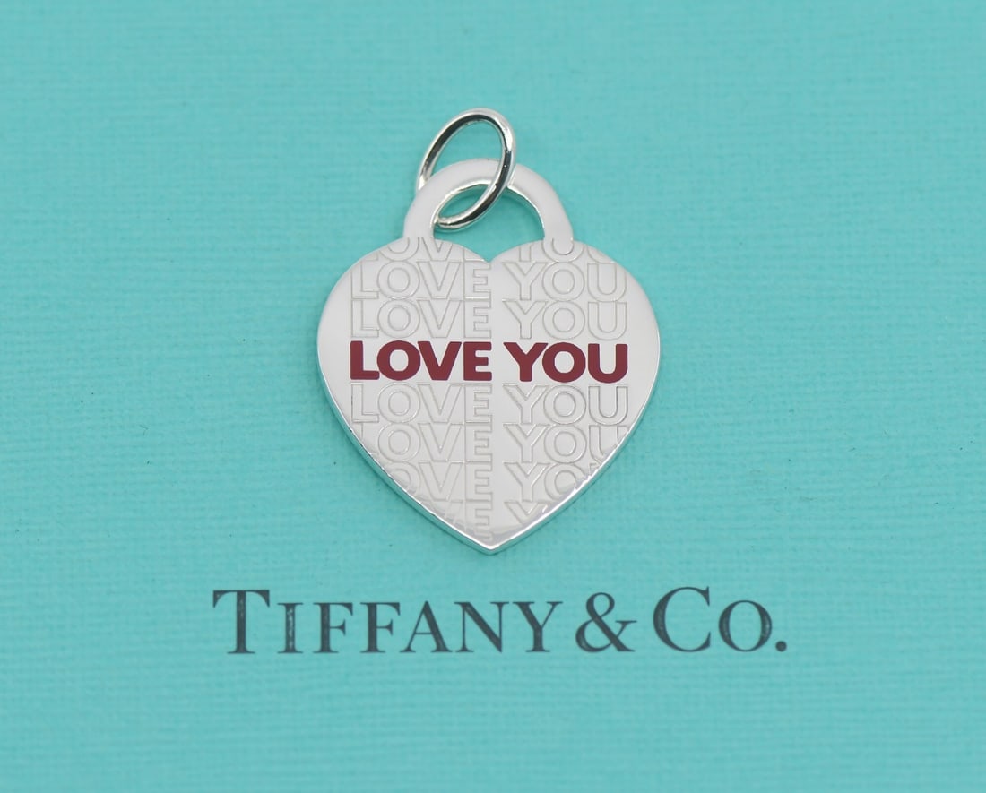 Tiffany & Co Love You 925 Sterling Silver Pendant Authentic: Tiffany & Co Love You 925 Sterling Silver Pendant Authentic This exquisite Tiffany & Co. Love You pendant is crafted from high-quality sterling silver with a metal purity of 925. The pendant showcases