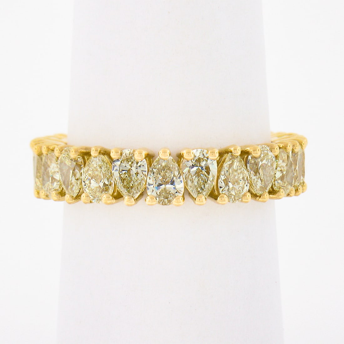 18K Yellow Gold Fancy Light Yellow Diamond Eternity Stack Band Ring 3.50ctw 24 Pear Cut: 18K Yellow Gold Fancy Light Yellow Diamond Eternity Stack Band Ring 3.50ctw 24 Pear Cut This exquisite 18K Yellow Gold Eternity Wedding Stack Band Ring features 24 alternating pear-shaped diamonds tot