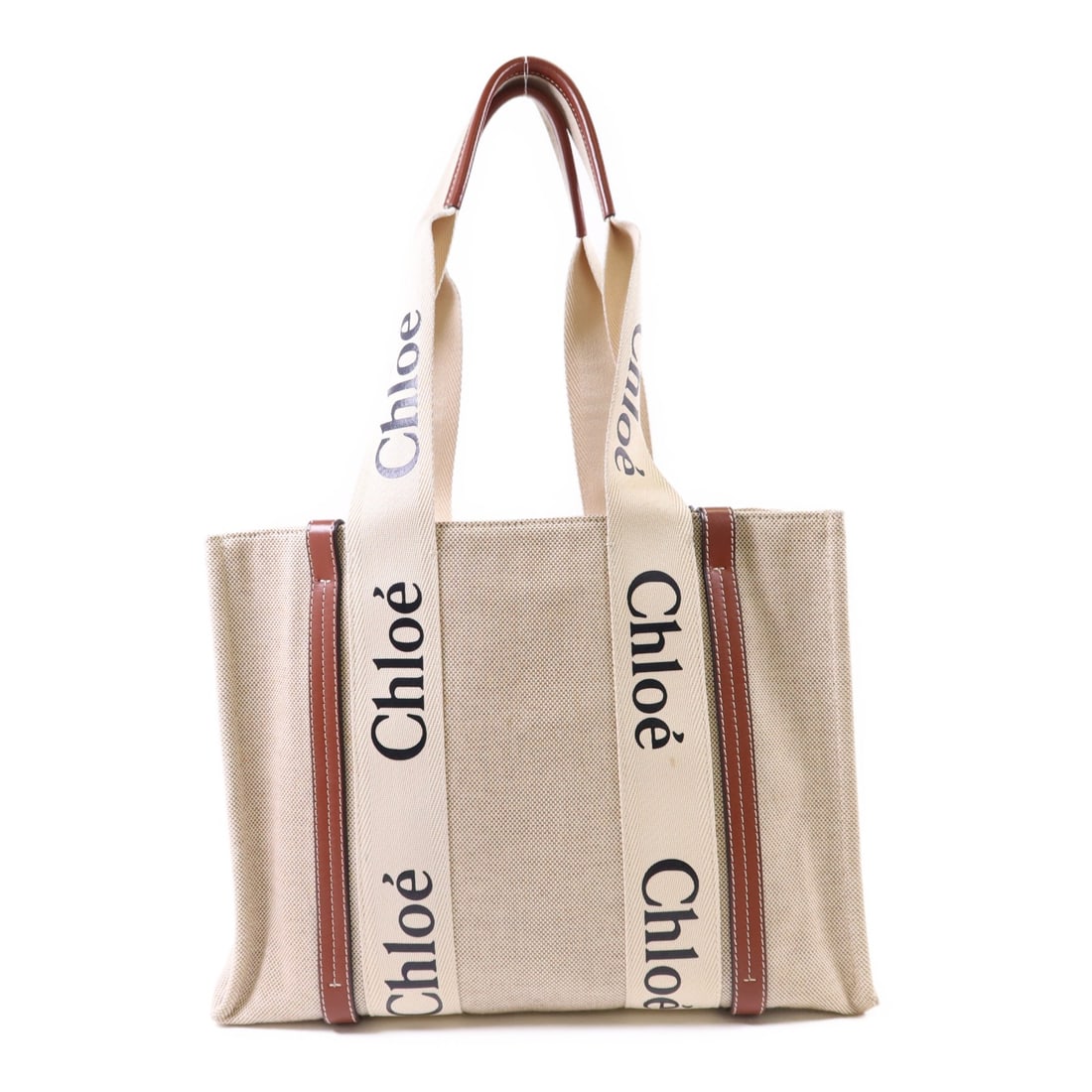 Chloe Woody Medium Canvas Tote in Beige and Brown: Chloe Woody Medium Canvas Tote in Beige and Brown This Chloe Woody Medium Tote Bag features a beige canvas exterior with brown accents. Designed as a regular size tote, it offers a spacious interior s