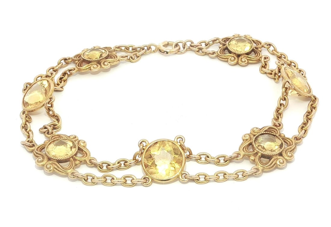 Art Nouveau Era 14k Gold Floral Cable Bracelet with Bezel Set Citrines: Art Nouveau Era 14k Gold Floral Cable Bracelet with Bezel Set Citrines This antique Art Nouveau bracelet features seven natural round-cut citrines in a golden yellow hue, each bezel set within a flora