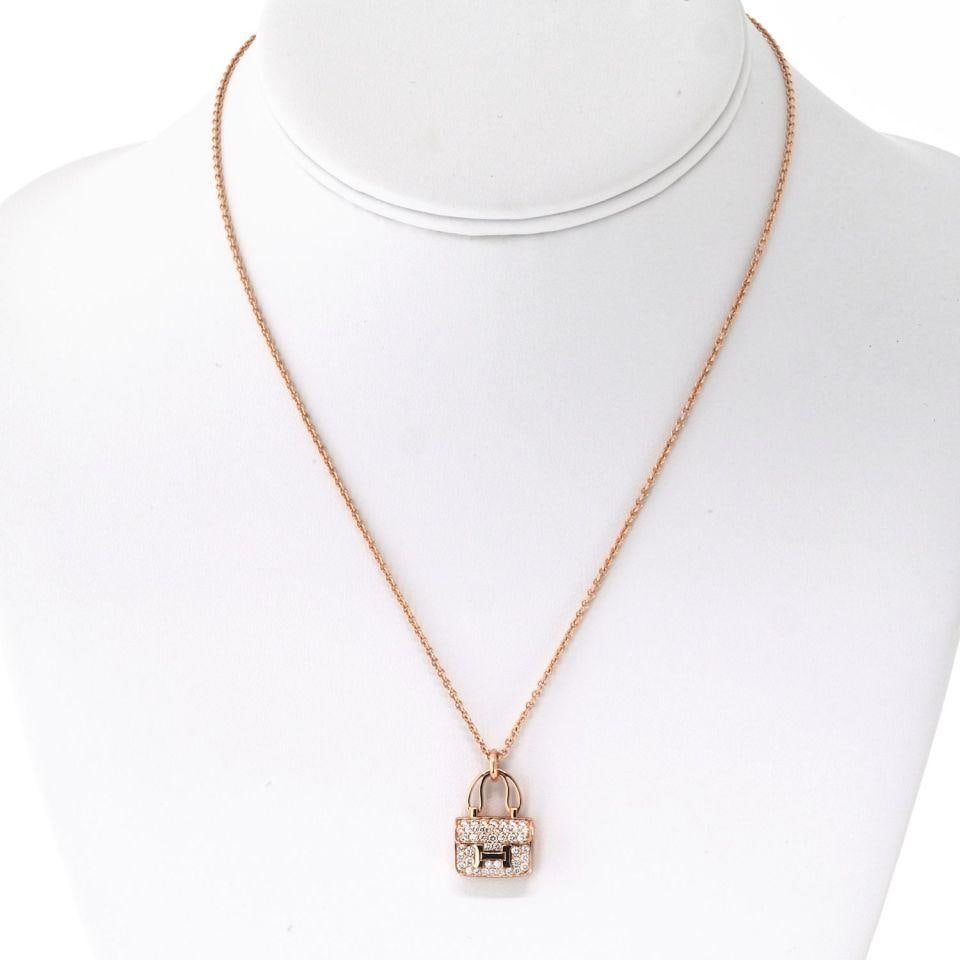 Hermes 18K Rose Gold Amulettes Constance Pendant Necklace with Diamonds: Hermes 18K Rose Gold Amulettes Constance Pendant Necklace with Diamonds The Hermes 18K Rose Gold Amulettes Constance Pendant Necklace is a refined expression of elegance and luxury. Crafted from warm