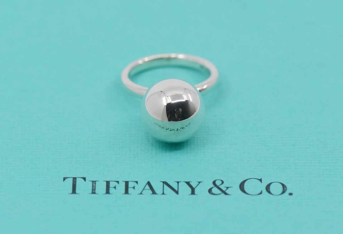 Tiffany & Co Sterling Silver Beaded Ring Size 4 Authentic: Tiffany & Co Sterling Silver Beaded Ring Size 4 Authentic Elevate your jewelry collection with this exquisite Tiffany & Co. Sterling Silver Bead Ring. This elegant ring features a beaded design and is