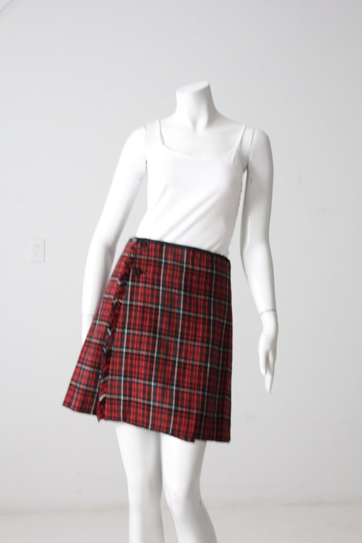 Vintage Red Black White Plaid A-Line Skirt with Buttons: Vintage Red Black White Plaid A-Line Skirt with Buttons This vintage plaid skirt showcases a classic red, black, and white plaid print. The A-line silhouette falls above the knee, offering a stylish a