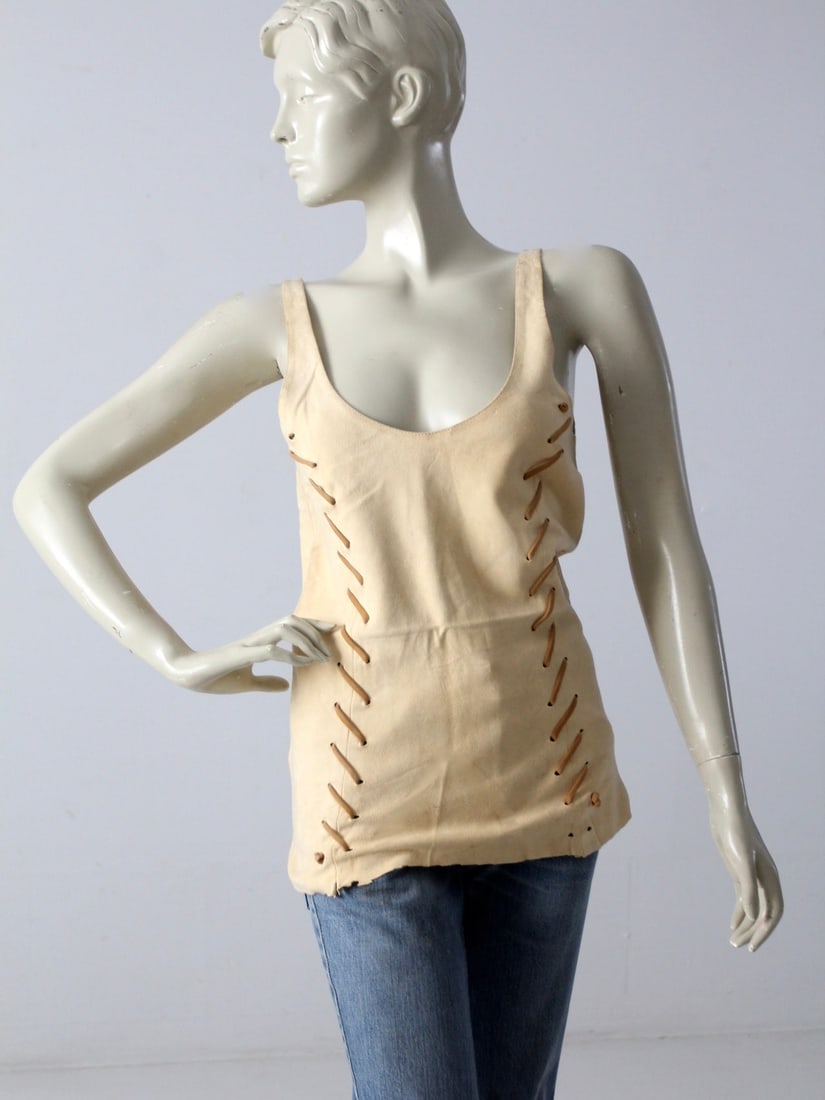 Vintage Beige Suede Boho Tank Top with Leather Lacing: Vintage Beige Suede Boho Tank Top with Leather Lacing Embrace the bohemian spirit with this vintage hippie suede tank top, crafted from supple beige suede. It features tan leather lacing that beautifu
