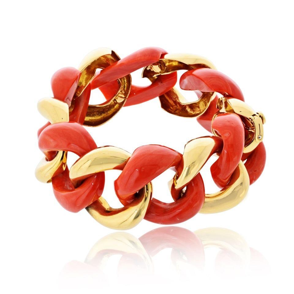 Coral and 18K Yellow Gold Link Bracelet by Seaman Schepps 7 Inch: Coral and 18K Yellow Gold Link Bracelet by Seaman Schepps 7 Inch This Seaman Schepps bracelet is crafted from 18K yellow gold and features oversized carved coral links paired with polished gold links,