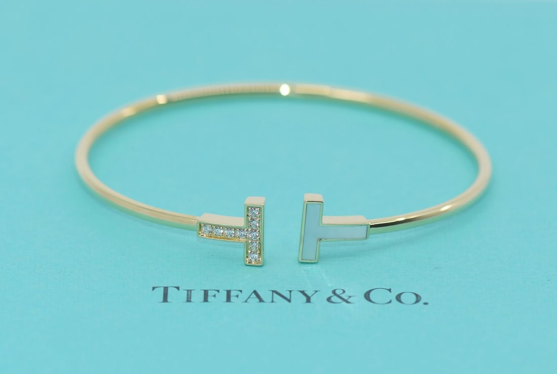 Tiffany & Co 18K Yellow Gold T Wire Diamond Bangle Bracelet: Tiffany & Co 18K Yellow Gold T Wire Diamond Bangle Bracelet Presenting a stunning Tiffany & Co. T Wire Diamond Bracelet, expertly crafted in 18K yellow gold. This elegant bangle style bracelet feature