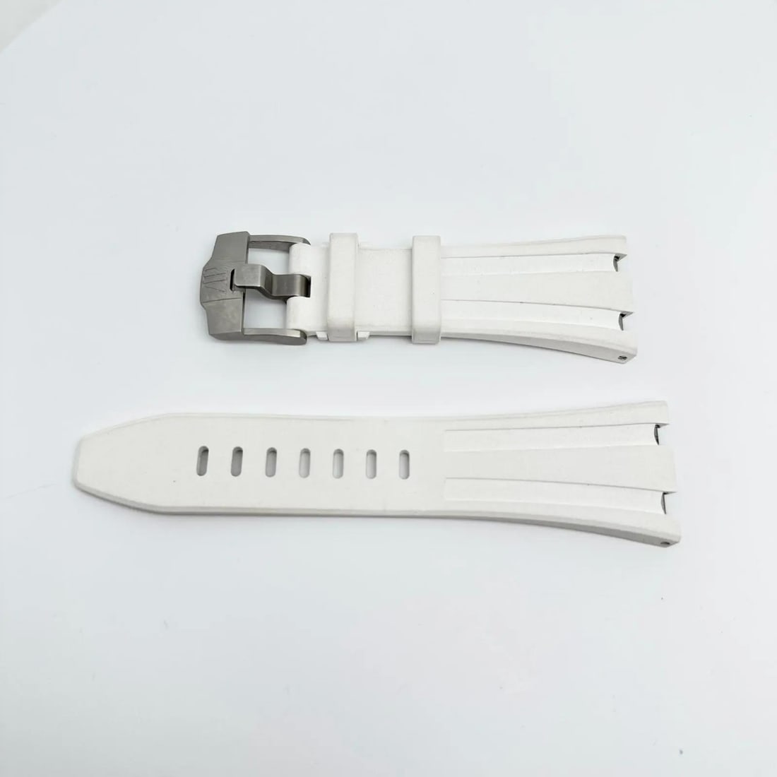 Audemars Piguet White Rubber Two-Piece Strap for Royal Oak 20mm: Audemars Piguet White Rubber Two-Piece Strap for Royal Oak 20mm Enhance your Audemars Piguet timepiece with this premium white rubber wristwatch band. Crafted for luxury, this two-piece strap is desig
