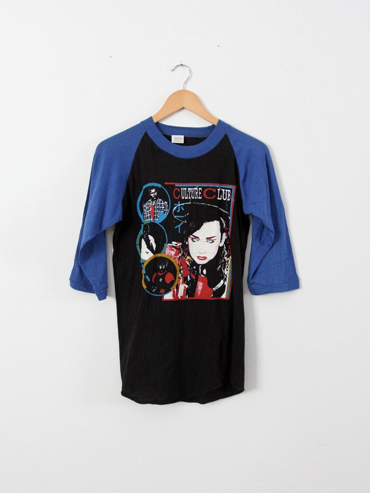 Vintage 1983 Culture Club T-Shirt with Boy George Graphic: Vintage 1983 Culture Club T-Shirt with Boy George Graphic Celebrate the iconic 1980s music scene with this vintage Culture Club t-shirt from their 1983 tour. Showcasing the vibrant Color By Numbers al