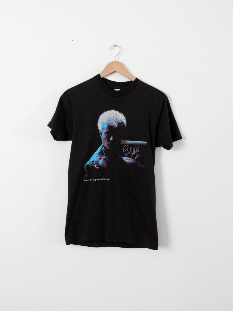 Vintage Billy Idol 1983 Rebel Yell T-Shirt Black Cotton Graphic Tee: Vintage Billy Idol 1983 Rebel Yell T-Shirt Black Cotton Graphic Tee This vintage Billy Idol t-shirt from the 1983 Rebel Yell promotion is a must-have for fans and collectors alike. Made from 100% cott