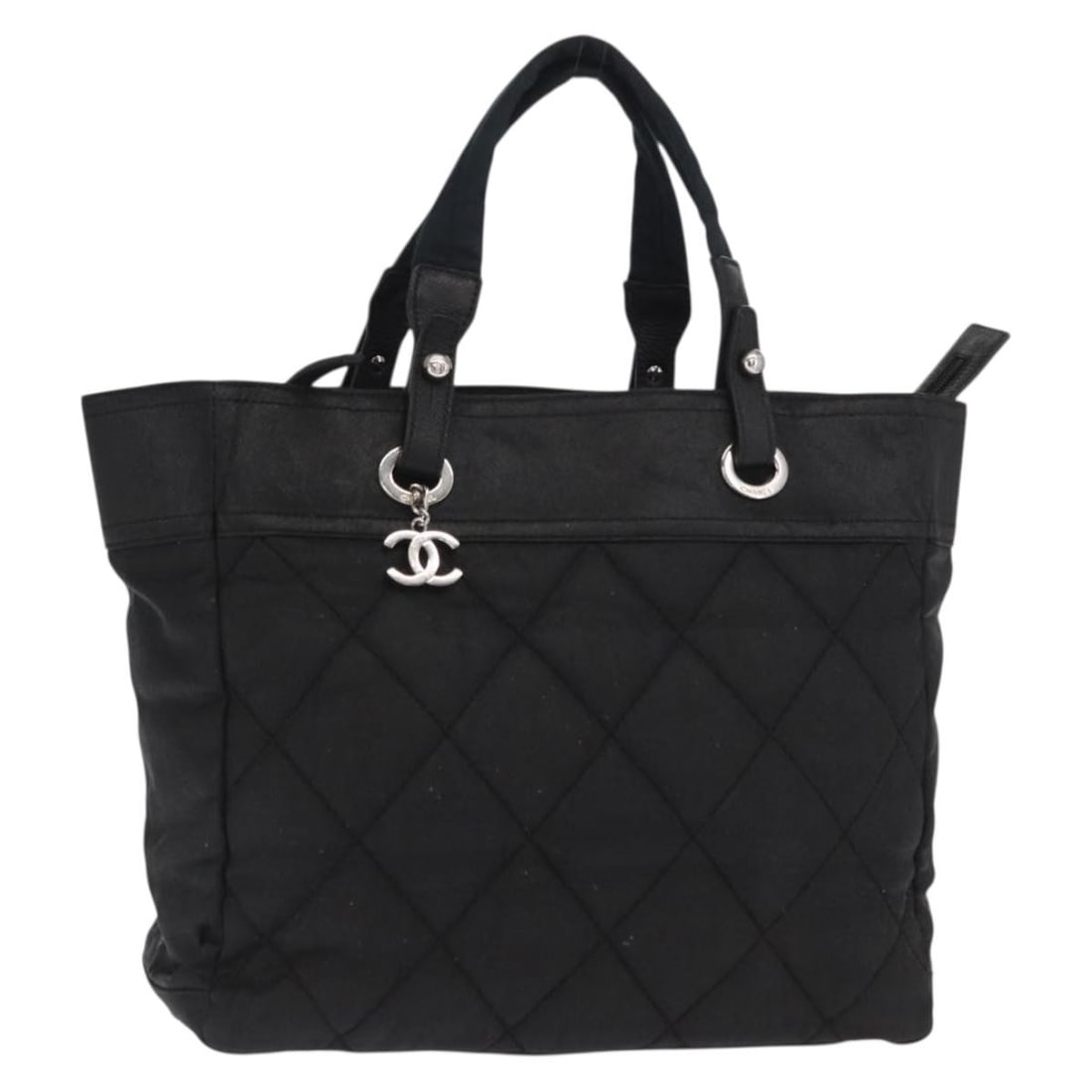 Black Canvas Handbag by CHANEL with Silver CC and Guarantee Card: Black Canvas Handbag by CHANEL with Silver CC and Guarantee Card This CHANEL handbag features a black and silver canvas exterior and is crafted in Italy. The bag has a structured silhouette with an ap