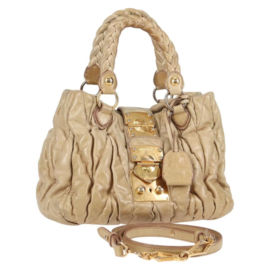 Miu Miu Beige Gold Leather Hand Bag with Strap Authentic: Miu Miu Beige Gold Leather Hand Bag with Strap Authentic This Miu Miu handbag is a stylish accessory crafted from high-quality leather in a chic beige and gold palette. With dimensions of approximatel