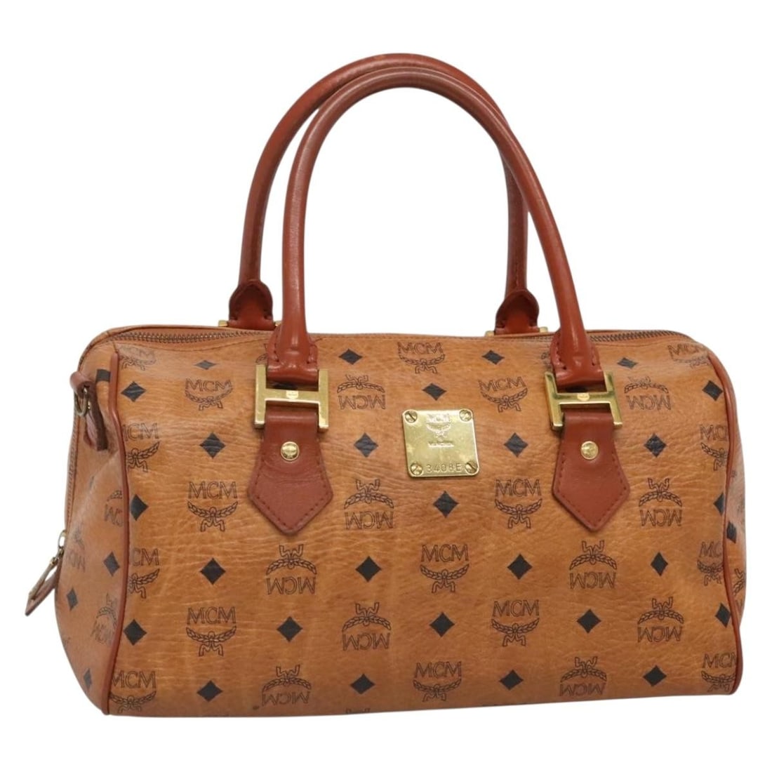 MCM Logogram Vicetos Hand Bag PVC Leather Brown Gold Made in Germany: MCM Logogram Vicetos Hand Bag PVC Leather Brown Gold Made in Germany This MCM Logogram Vicetos Hand Bag is a stylish accessory made from durable PVC leather in a rich brown and gold color scheme. With