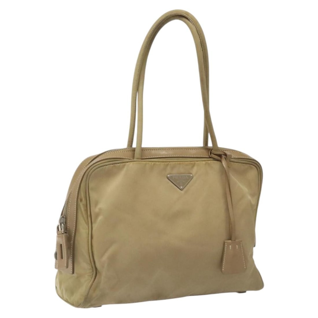 PRADA Beige Silver Nylon Hand Bag with Clochette Made in Italy: PRADA Beige Silver Nylon Hand Bag with Clochette Made in Italy This PRADA Hand Bag is a stylish accessory crafted from durable nylon in a chic beige and silver color combination. With dimensions of ap