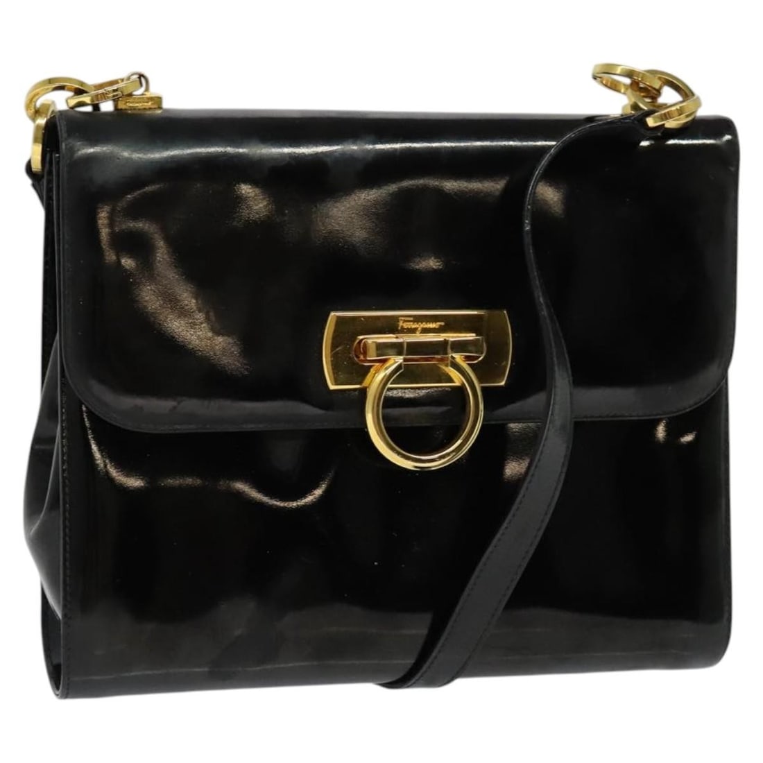 Black and Gold Enamel Gancini Shoulder Bag by Salvatore Ferragamo: Black and Gold Enamel Gancini Shoulder Bag by Salvatore Ferragamo This Salvatore Ferragamo Gancini shoulder bag features a striking black and gold enamel exterior. Made in Italy, the bag has a structu