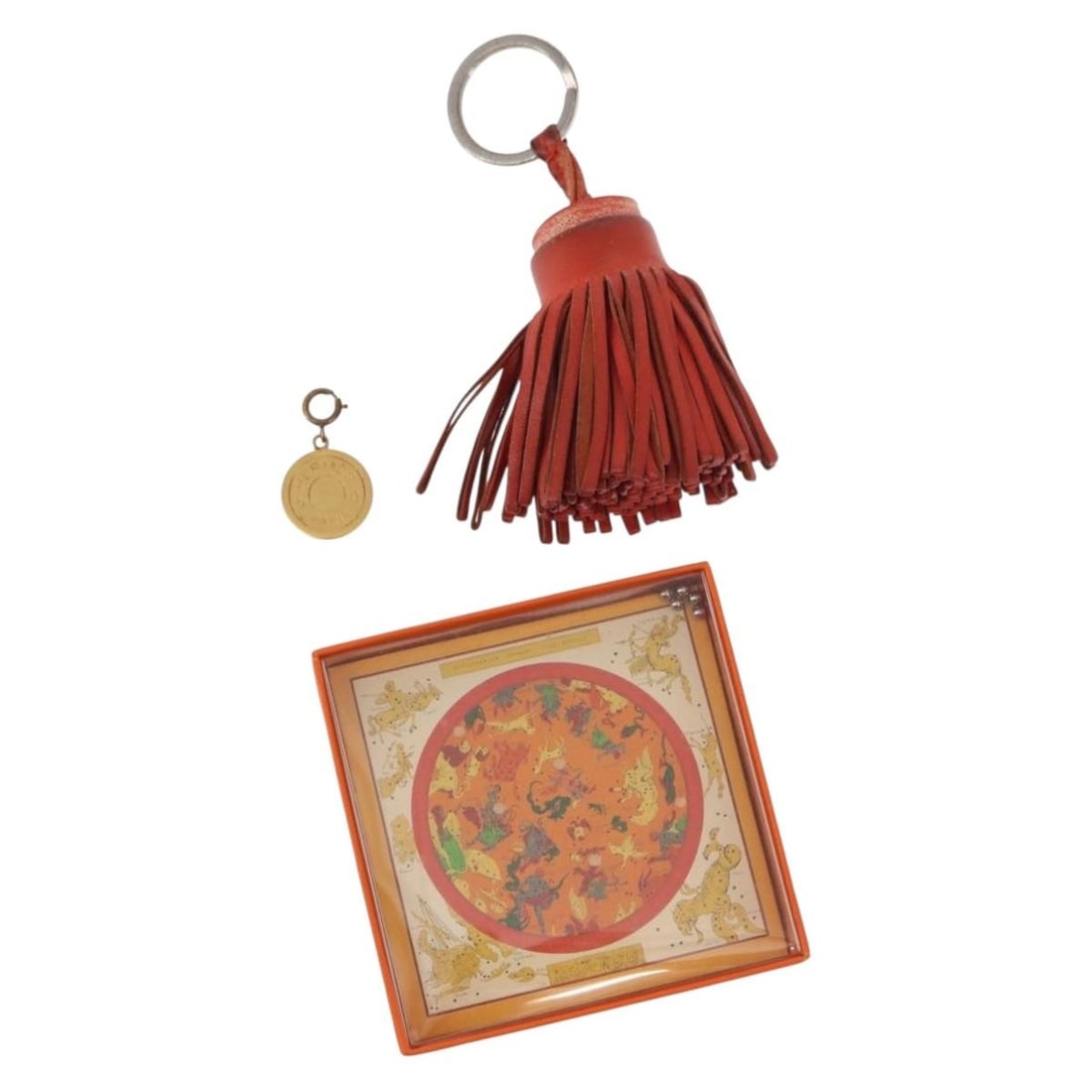 HERMES Charm Set of 3 Red Gold Silver Authentic: HERMES Charm Set of 3 Red Gold Silver Authentic This exquisite HERMES charm set features three unique pieces crafted from durable metal, showcasing a stunning combination of red, gold, and silver colo