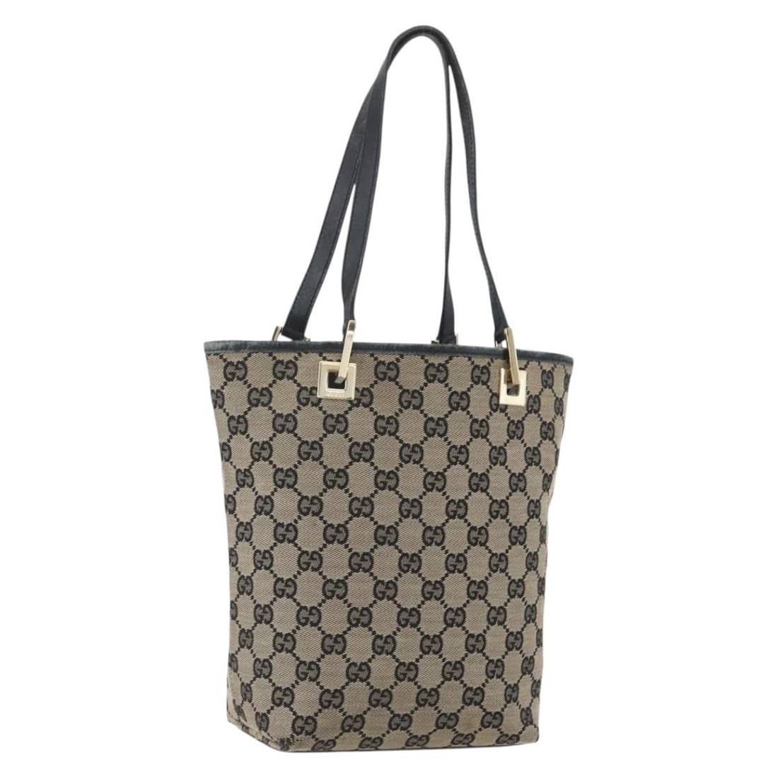 Navy and Gold GG Canvas Tote by Gucci 002 1099 Italy: Navy and Gold GG Canvas Tote by Gucci 002 1099 Italy This is a Gucci GG Canvas tote bag in navy and gold, crafted in Italy. The bag features a GG canvas exterior, dual handles, and a spacious interior