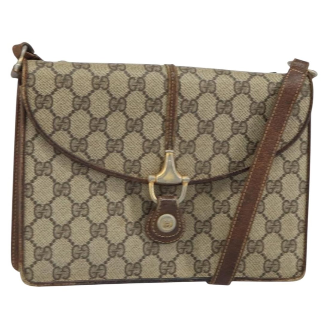 Beige Gold PVC GG Supreme Horsebit Shoulder Bag by Gucci Model 33 001 3376: Beige Gold PVC GG Supreme Horsebit Shoulder Bag by Gucci Model 33 001 3376 This is a Gucci GG Supreme Horsebit shoulder bag crafted in beige and gold PVC leather with GG canvas detailing. The bag feat