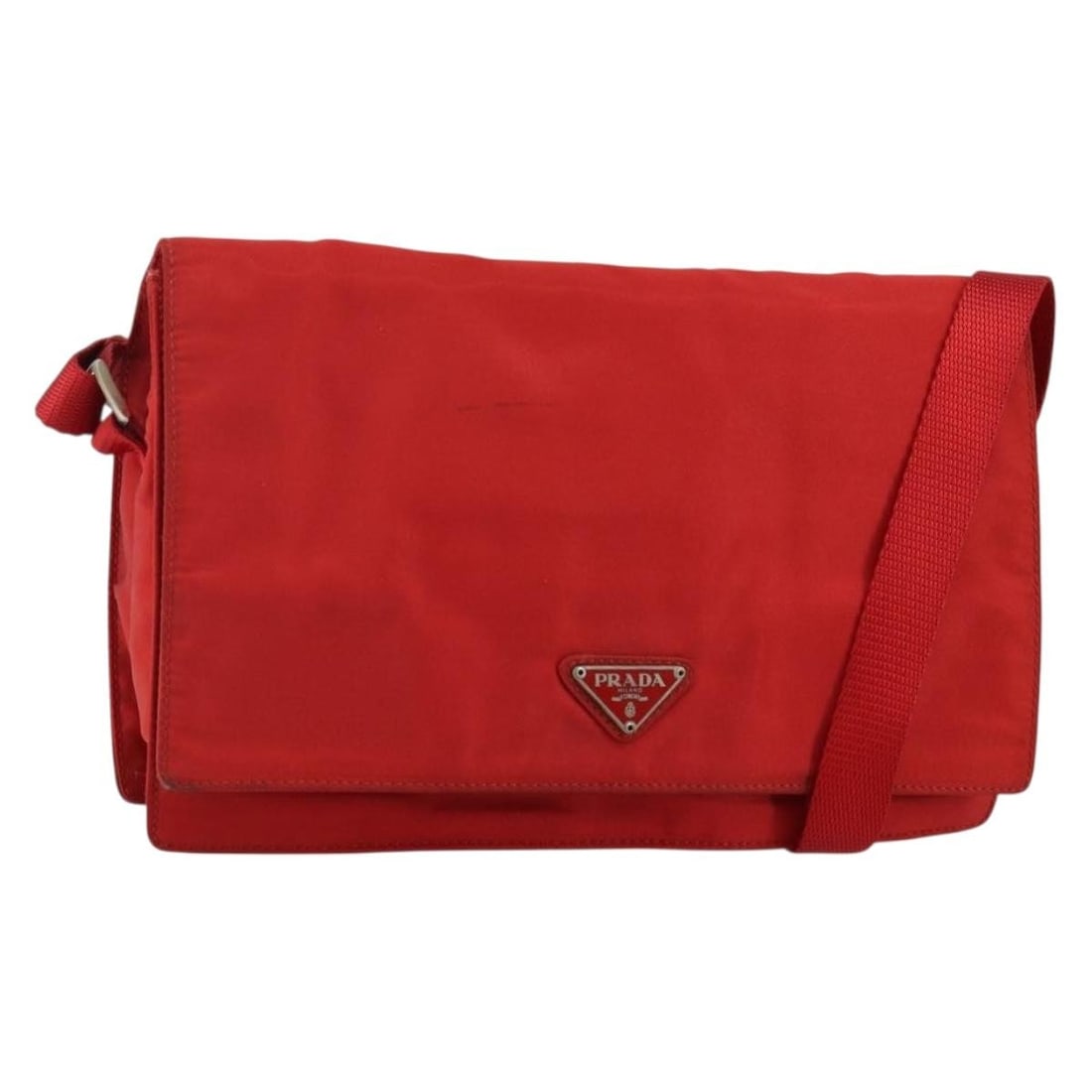 Red Nylon Prada Shoulder Purse with Silver Accents Made in Italy: Red Nylon Prada Shoulder Purse with Silver Accents Made in Italy This PRADA shoulder bag is crafted from red and silver nylon and was made in Italy. It features a practical shoulder strap with an adju