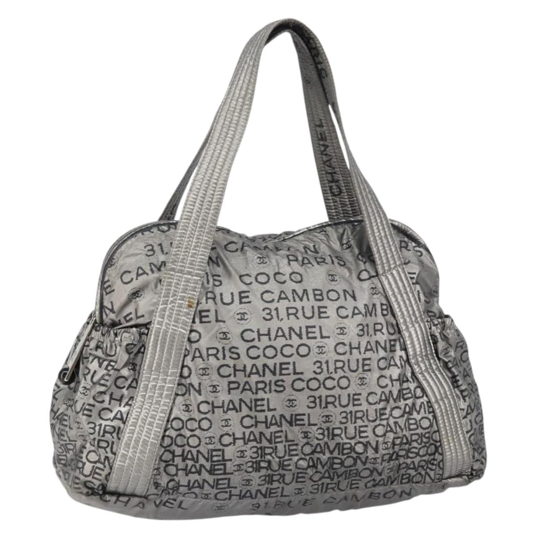 Silver Nylon Tote with CC Logo by CHANEL Unlimited: Silver Nylon Tote with CC Logo by CHANEL Unlimited This CHANEL Unlimited tote bag features a silver nylon exterior with the signature CC detail. Crafted in Italy, the bag offers a spacious interior an