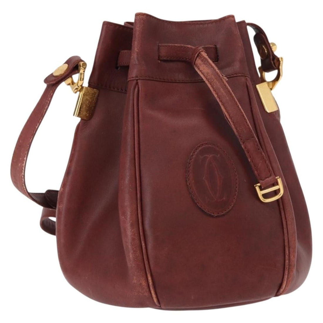 CARTIER Must Line Bordeaux Leather Shoulder Bag with Gold Accents: CARTIER Must Line Bordeaux Leather Shoulder Bag with Gold Accents This CARTIER Must Line Shoulder Bag is a stylish accessory crafted from high-quality leather in a rich bordeaux color with gold accent