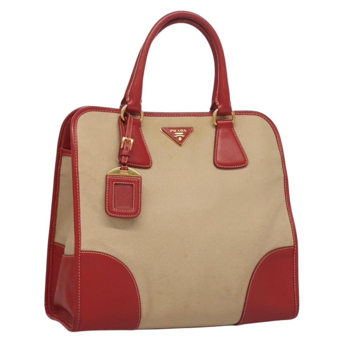 PRADA Red Gold Canvas Tote Bag with Name Tag: PRADA Red Gold Canvas Tote Bag with Name Tag This authentic PRADA tote bag combines functionality with luxury, crafted from durable canvas in a striking red and gold color scheme. Ideal for daily use,