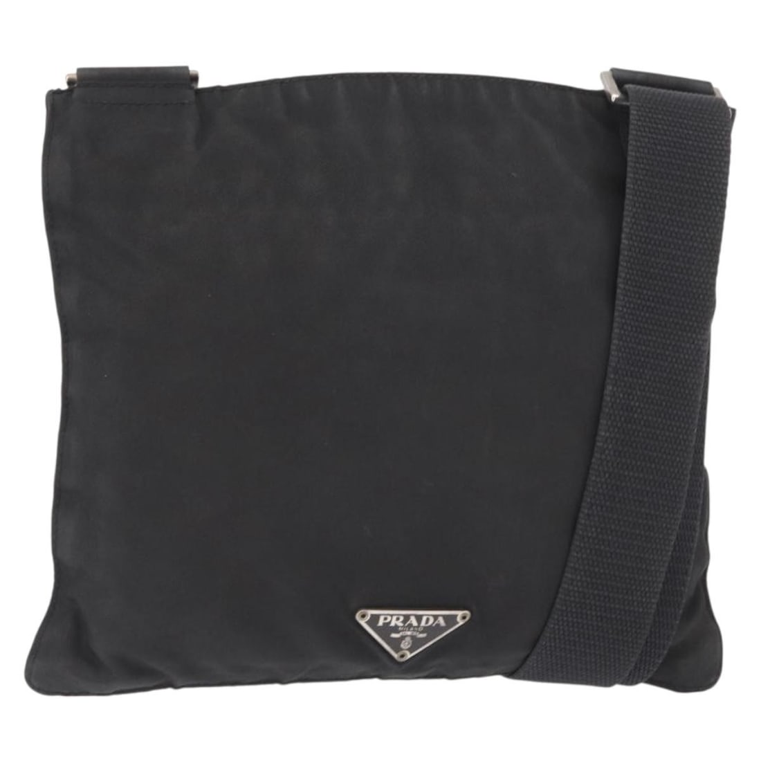 Black Nylon Prada Shoulder Purse with Silver Accents Made in Italy: Black Nylon Prada Shoulder Purse with Silver Accents Made in Italy This Prada shoulder bag is crafted from black nylon with silver-tone accents and features an adjustable shoulder strap. The bag is ma