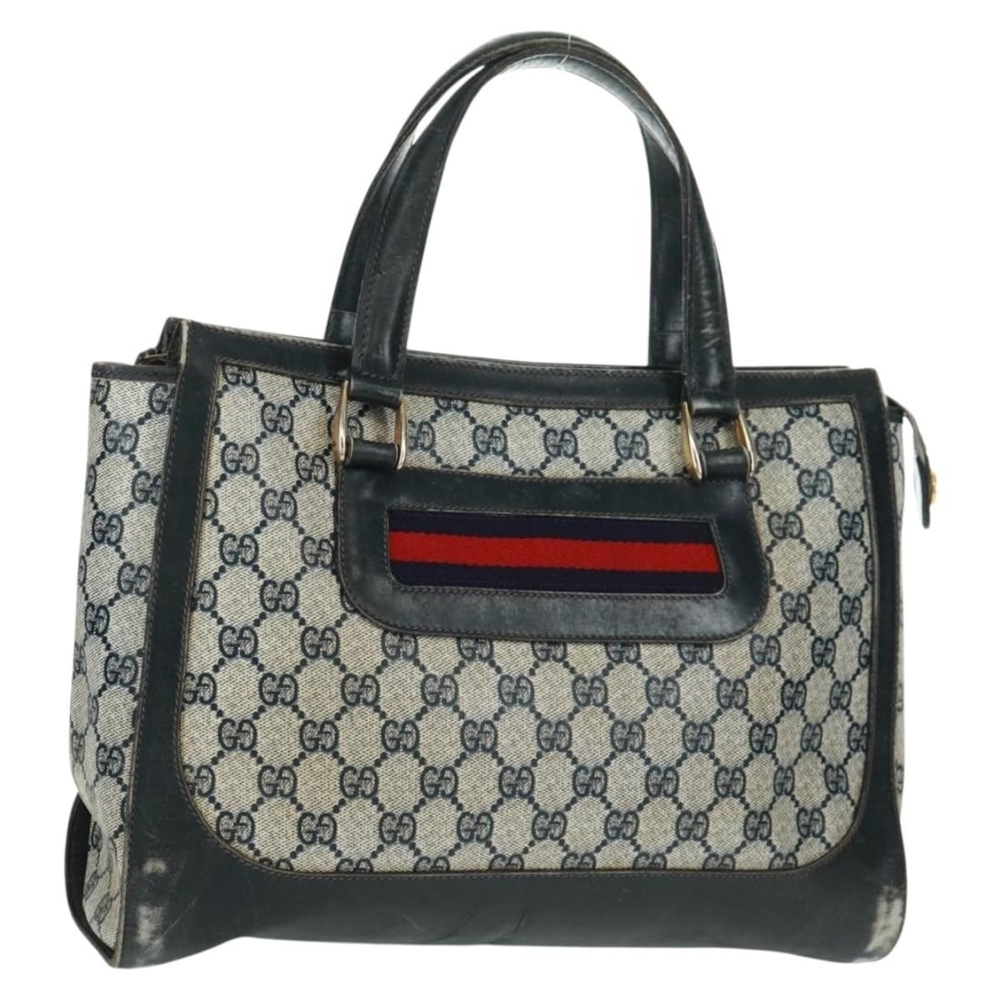 Navy GG Supreme Sherry Line Gucci Handbag in PVC with Gold Accents: Navy GG Supreme Sherry Line Gucci Handbag in PVC with Gold Accents This is a GUCCI GG Supreme Sherry Line handbag crafted from navy and gold PVC leather with GG canvas accents. The bag is made in Ital