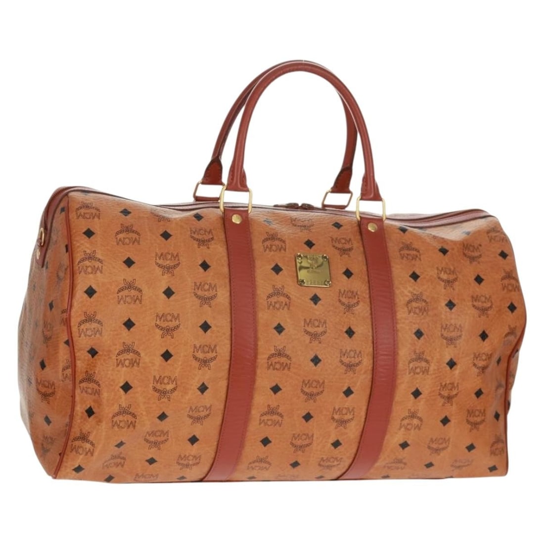 MCM Brown Boston Bag PVC Leather with Gold Tone Details: MCM Brown Boston Bag PVC Leather with Gold Tone Details This MCM Boston Bag features the signature Logogram Vicetos pattern and is crafted from brown PVC leather with gold accents. The bag has a spaci
