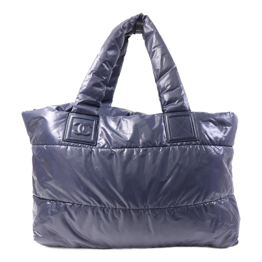 Navy Nylon Coco Cocoon Handbag by CHANEL with Silver CC Hardware: Navy Nylon Coco Cocoon Handbag by CHANEL with Silver CC Hardware This CHANEL Coco Cocoon handbag features a navy nylon exterior and a spacious design. Crafted in France, it is designed for regular use