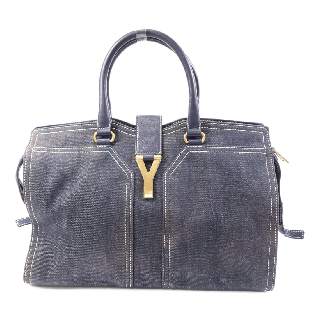 Saint Laurent Cabas Chyc Denim Navy Handbag with Gold Hardware: Saint Laurent Cabas Chyc Denim Navy Handbag with Gold Hardware This Yves Saint Laurent Cabas Chyc handbag features a denim exterior in a navy color. The bag is designed with gold hardware and showcase