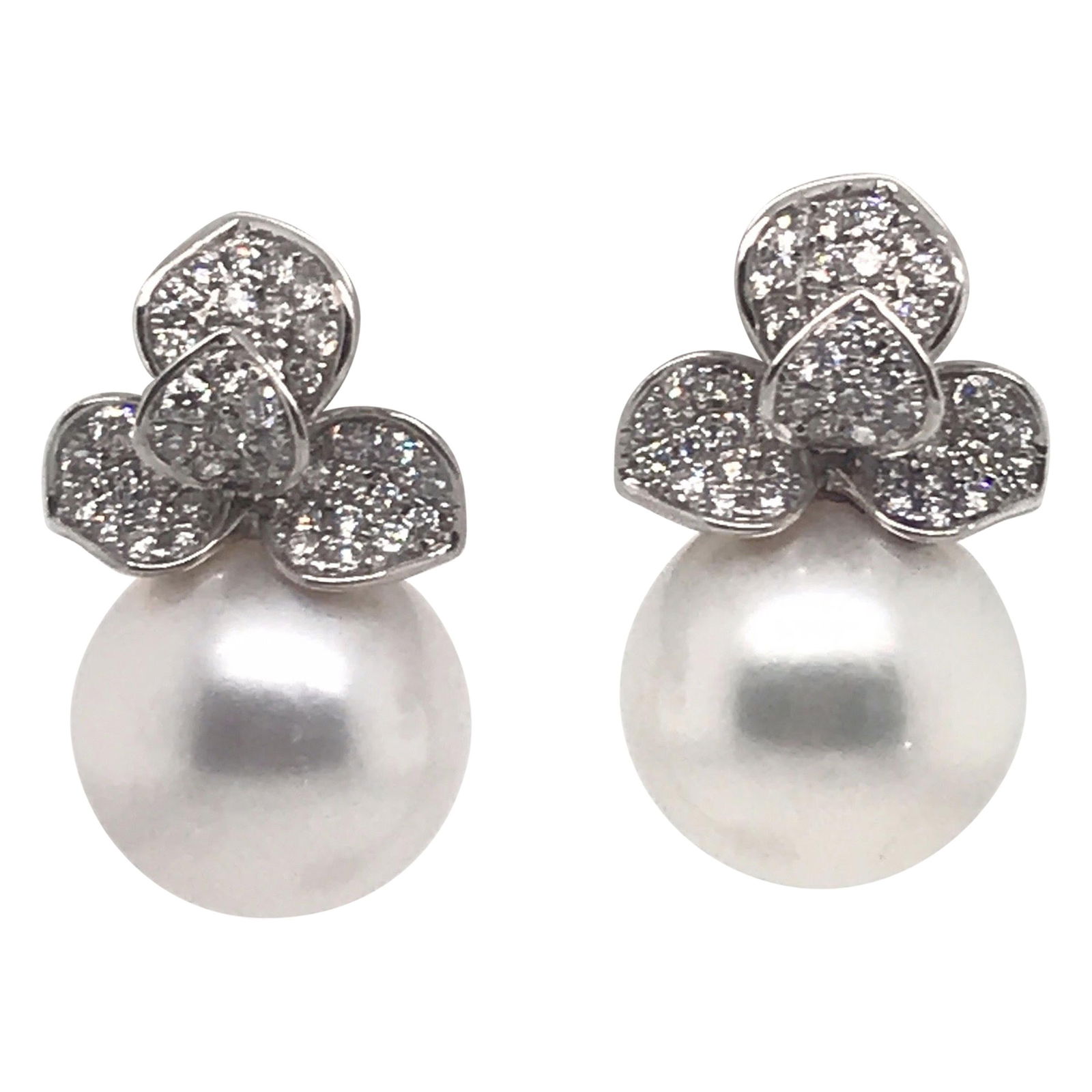 18K White Gold Drop Earrings with South Sea Pearls and 0.98ct Diamonds: 18K White Gold Drop Earrings with South Sea Pearls and 0.98ct Diamonds These exquisite Diamond Petal Floral Drop Earrings are crafted from 18KT white gold, showcasing a contemporary design. Each earri