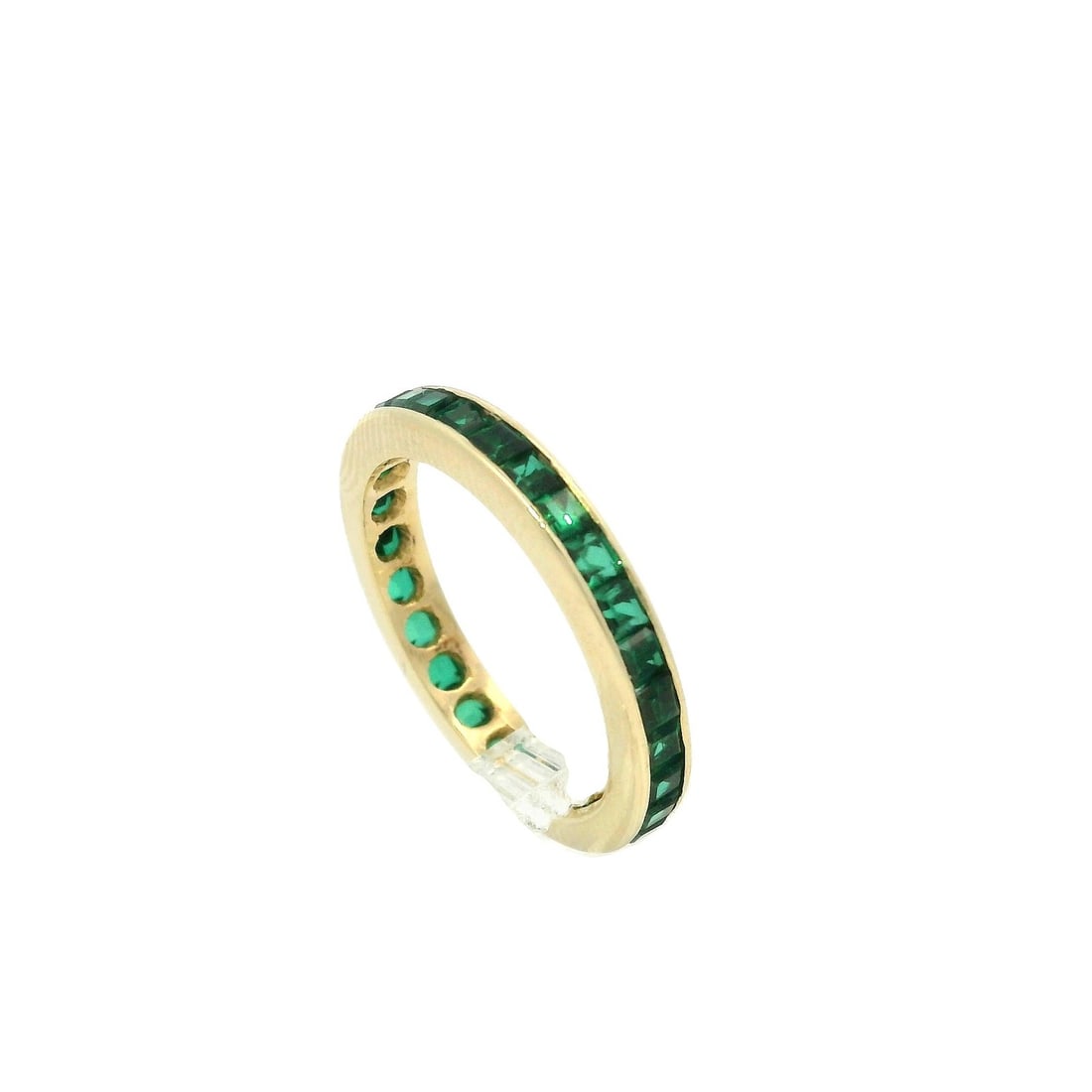 14k Yellow Gold Square Step Channel Green Stone Eternity Band Ring: 14k Yellow Gold Square Step Channel Green Stone Eternity Band Ring This exquisite eternity band ring features a stunning arrangement of numerous square step cut green stones, channel set to highlight