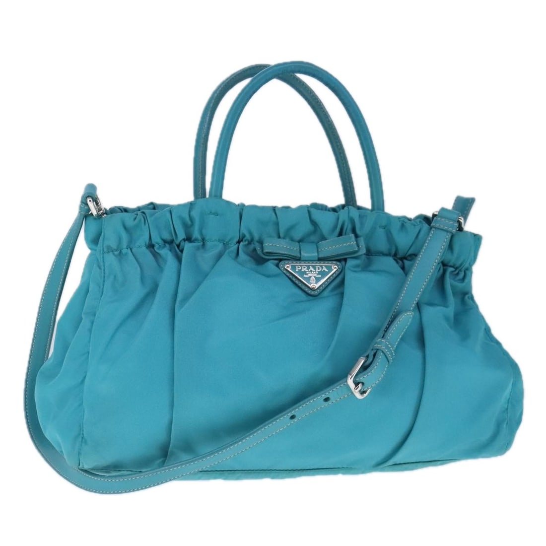 Prada Blue Bow Convertible Handbag with Dual Carry Options: Prada Blue Bow Convertible Handbag with Dual Carry Options This Prada Bow Convertible Tote in blue is a stylish handbag crafted for women. The bag features a spacious interior, dual carrying options w