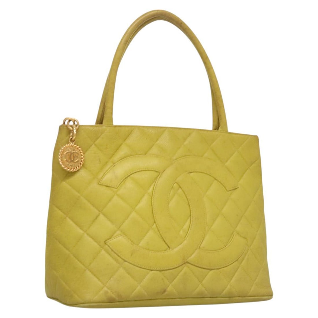 Yellow Chanel Medallion Tote Bag for Women: Yellow Chanel Medallion Tote Bag for Women This Chanel Medallion Tote in yellow is designed for women and features a spacious interior suitable for everyday use. The bag shows signs of use, including