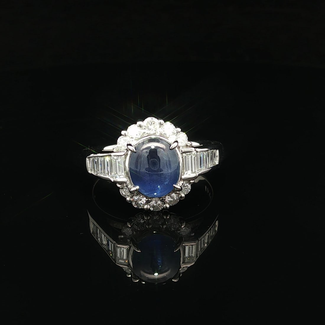 Platinum Cocktail Ring with Color Change Star Sapphire and Baguette Diamonds: Platinum Cocktail Ring with Color Change Star Sapphire and Baguette Diamonds This exquisite cocktail ring features a captivating natural star sapphire that exhibits a stunning color change from blue t