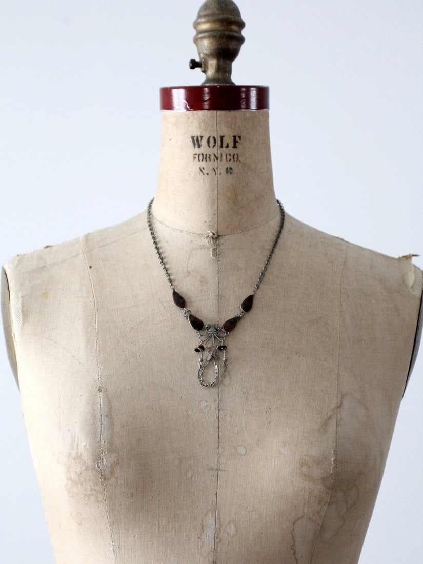 1970s Vintage Filigree Necklace with Obsidian Stones: 1970s Vintage Filigree Necklace with Obsidian Stones Discover a stunning vintage piece from the 1970s with this exquisite filigree and stone necklace. Crafted from silver tone metal, the intricate fil