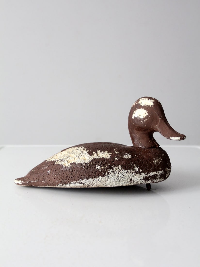 1950s Vintage Foam Duck Decoy Brown Durlon with Metal Hook: 1950s Vintage Foam Duck Decoy Brown Durlon with Metal Hook This vintage foam duck decoy, dating back to the 1950s-1960s, is crafted from a durable foam material often referred to as Durlon. The decoy