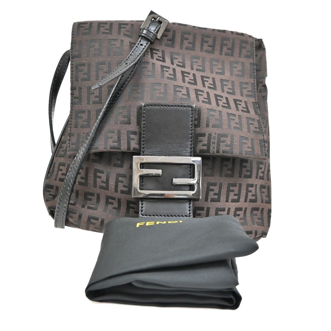 Vintage Fendi Brown Flap Shoulder Crossbody Bag: Vintage Fendi Brown Flap Shoulder Crossbody Bag This vintage Fendi flap crossbody bag features a brown canvas exterior with signs of wear, including scuffs, dirt, and discoloration. The interior is in