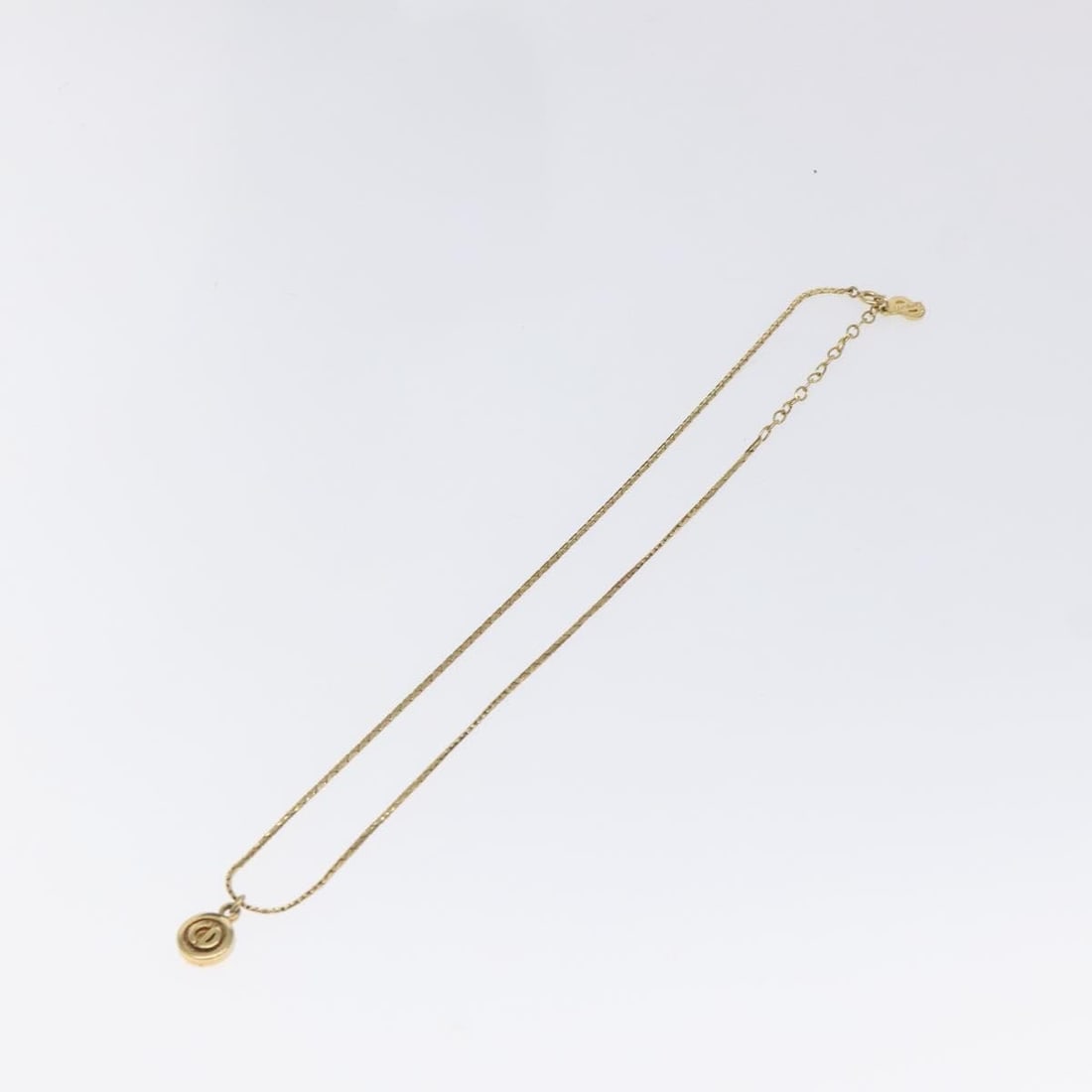 Gold Tone Christian Dior Pendant Necklace with Circular CD Charm: Gold Tone Christian Dior Pendant Necklace with Circular CD Charm This Christian Dior round pendant necklace features a gold-tone finish and is designed for women. The necklace is in good condition wit