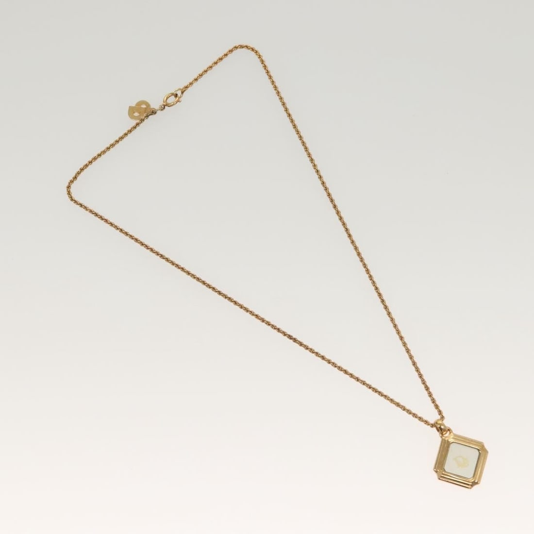 Vintage Dior Necklace with Signature Gold Finish Logo: Vintage Dior Necklace with Signature Gold Finish Logo This Christian Dior vintage necklace features the iconic Dior logo and is designed for women. The necklace has a gold finish and shows some surfac