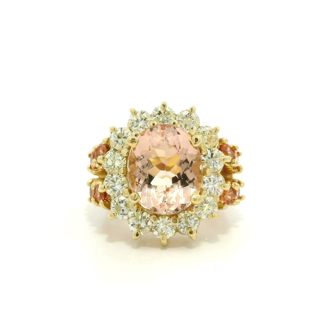 14k Yellow Gold Morganite Diamond Halo Cocktail Statement Ring: 14k Yellow Gold Morganite Diamond Halo Cocktail Statement Ring This stunning cocktail ring showcases a large natural morganite center stone, elegantly surrounded by a halo of brilliant diamonds. The m