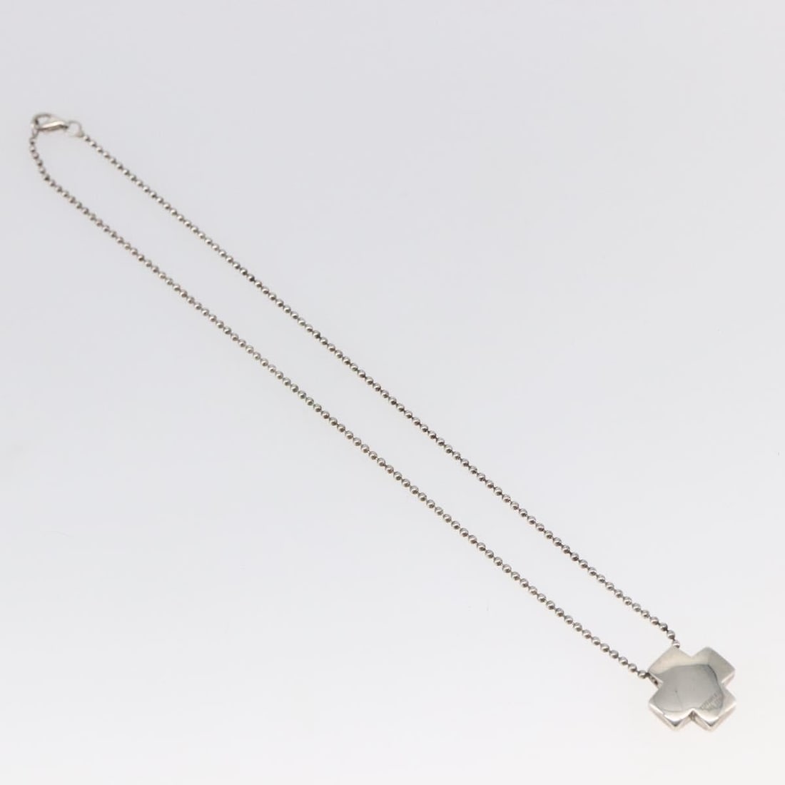 Roman Cross Pendant Necklace in Silver by Tiffany & Co.: Roman Cross Pendant Necklace in Silver by Tiffany & Co. This pre-owned Tiffany & Co. Roman Cross necklace is crafted from silver and features a classic cross design. The necklace is intended for femal
