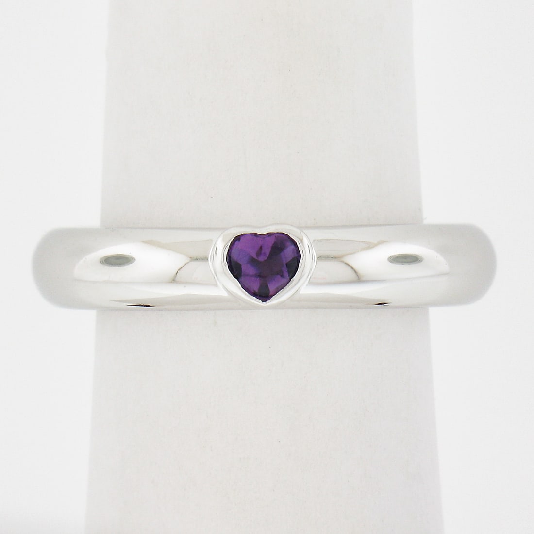 Tiffany & Co. 18k White Gold Heart Amethyst Bezel Set Ring: Tiffany & Co. 18k White Gold Heart Amethyst Bezel Set Ring This exquisite Tiffany & Co. ring features a stunning heart-shaped natural amethyst, elegantly bezel set in solid 18k white gold. With a poli
