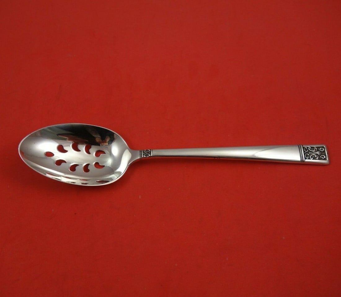 Towle Laureate Sterling Silver Slotted Serving Spoon 8 3/4 inches 9-Hole: Towle Laureate Sterling Silver Slotted Serving Spoon 8 3/4 inches 9-Hole Discover the elegance of the Laureate pattern by Towle with this exquisite sterling silver serving spoon. Measuring 8 3/4 inche