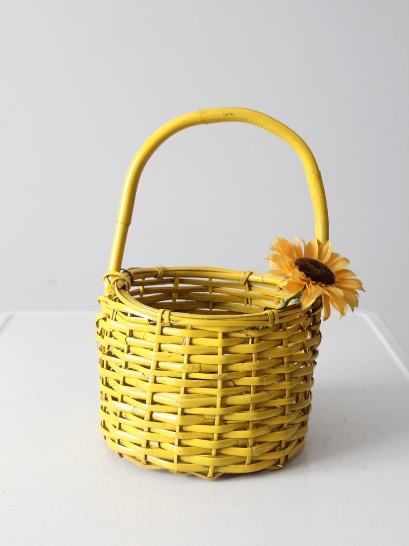 Vintage Sunflower Yellow Wicker Basket with Handle: Vintage Sunflower Yellow Wicker Basket with Handle Add a cheerful touch to your home with this vintage yellow wicker handle basket. The vibrant sunflower yellow design makes it an ideal catchall for v
