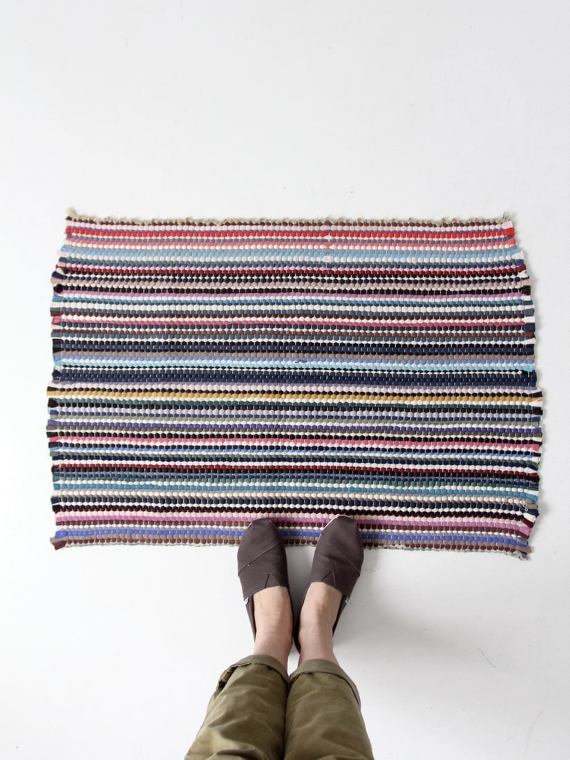 Charming Vintage Rainbow Striped Throw Rag Rug 34 x 23.5: Charming Vintage Rainbow Striped Throw Rag Rug 34 x 23.5 Enhance your space with this charming vintage throw rag rug, a delightful floor mat showcasing an array of vibrant colors. The rug features a b
