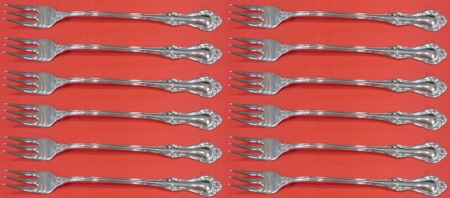 International Sterling Silver Joan of Arc Cocktail Fork Set 12 pcs: International Sterling Silver Joan of Arc Cocktail Fork Set 12 pcs Introducing the Joan of Arc Sterling Silver Cocktail Fork Set, a stunning collection of 12 forks, each measuring 5 1/2". This exquisi