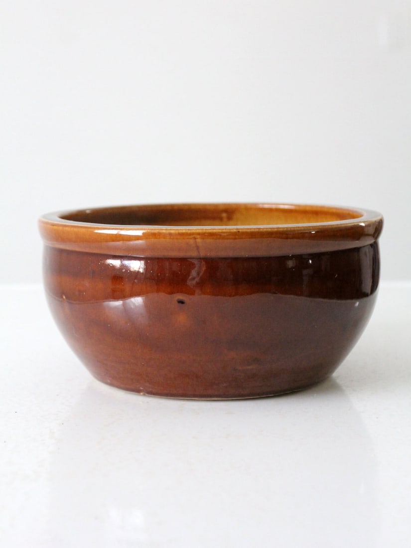 Antique Farmhouse Stoneware Bowl 9.75 Inch Brown Glaze Cream Interior: Antique Farmhouse Stoneware Bowl 9.75 Inch Brown Glaze Cream Interior This antique stoneware bowl features a charming farmhouse design with a brown glazed exterior and a cream interior. It is in good