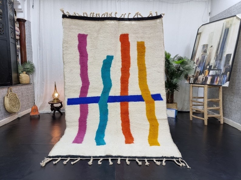 Authentic Moroccan Berber Carpet 100% Sheep Wool 6.56 x 3.28 ft: Authentic Moroccan Berber Carpet 100% Sheep Wool 6.56 x 3.28 ft This authentic handmade Moroccan Berber carpet features a stunning design of assorted lines in shades of pink, light blue, orange, brown