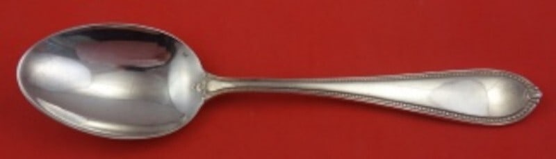 Tuttle Triumph Sterling Silver 9 Inch Serving Spoon: Tuttle Triumph Sterling Silver 9 Inch Serving Spoon This exquisite 9-inch serving spoon is crafted from high-quality sterling silver and features the elegant Triumph pattern by Tuttle. The spoon is in